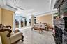 Living area with ornamental molding, a fireplace, and healthy amount of natural light