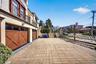 View of patio / terrace featuring a gate, an attached garage, and a residential view