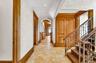 Corridor featuring arched walkways, recessed lighting, and a textured wall