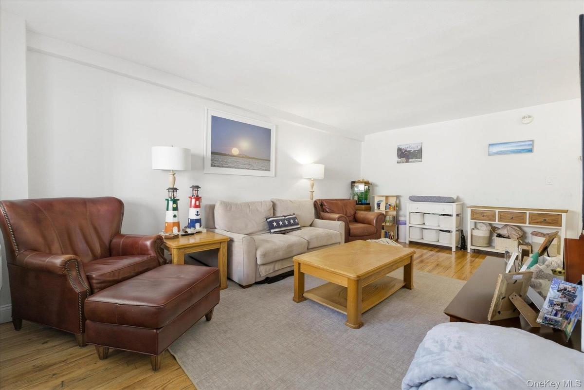 Spacious living room with hardwood floors and extra wide windows