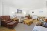 Spacious living room with hardwood floors and extra wide windows