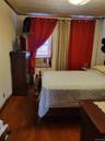 Bedroom with dark wood-type flooring and ornamental molding