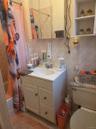 Full bath featuring shower / bath combo, tile walls, backsplash, vanity, and light tile patterned floors
