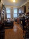 Kitchen with light wood-style flooring and stove