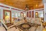 Living area with crown molding, wooden ceiling, wood finished floors, and ceiling fan