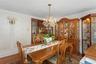 Dining area featuring a chandelier, ornamental molding, and wood finished floors