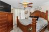 Bedroom featuring light carpet and a ceiling fan