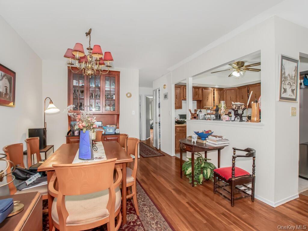 Apt 2 - Dining room featuring wood finished floors, ceiling fan, and a chandelier