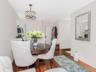 Dining space with wood finished floors and a chandelier