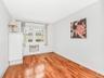 Unfurnished room with a wall mounted AC and light wood-type flooring