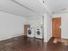 Basement - Washroom featuring baseboard heating, washer and clothes dryer, and tile patterned floors