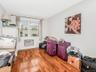 Apt 2 - Rec room with a wall mounted AC and hardwood / wood-style flooring