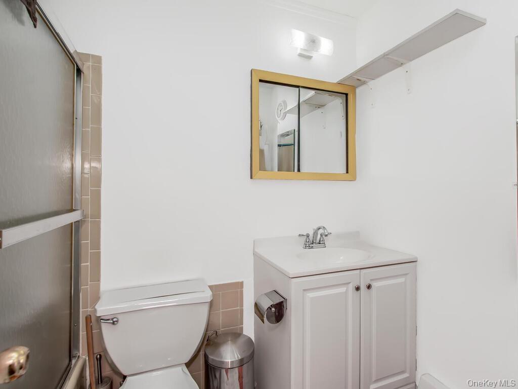 Apt 2 - Full bath with vanity and shower / bath combination with glass door