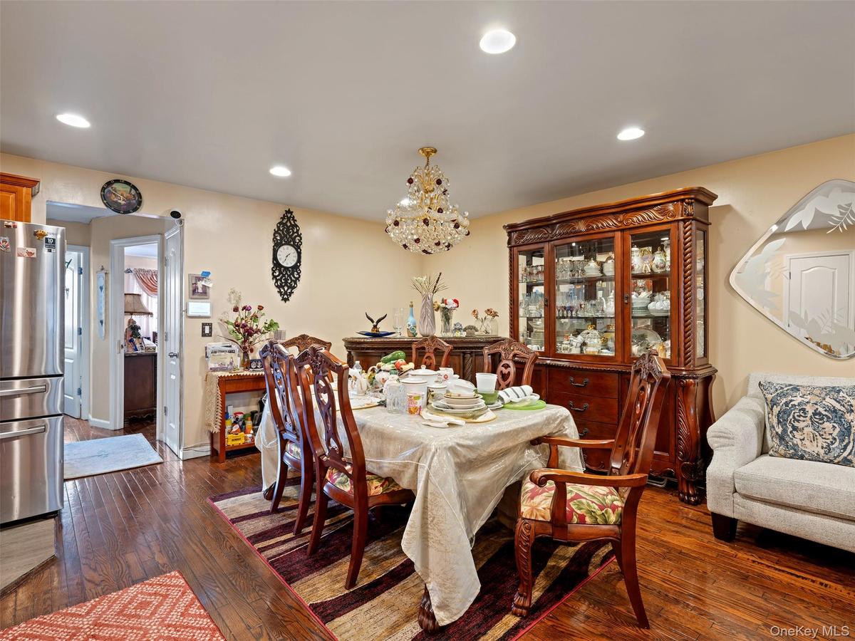 Dining area featuring hardwood floors, recessed lighting, and a chandelier