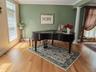 oak wood finished floors, crown molding, and decorative columns