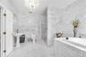 Primary 2nd floor marble bathroom with Jetted tub, separate  shower, and two pedestal sinks.