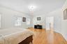 primary Bedroom suite on 2nd floor featuring oak wood finished floors and a chandelier