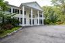 Neoclassical / greek revival house with a porch and asphalt driveway plenty of guest parking
