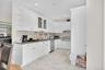 Kitchen featuring open shelves, white cabinetry, glass insert cabinets, backsplash, and recessed lighting