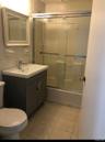 Full bathroom featuring tile patterned floors, vanity, toilet, and bath / shower combo with glass door
