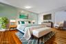 Bedroom with baseboards and hardwood / wood-style floors