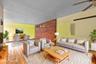 Living area featuring baseboards, light wood finished floors, and ceiling fan