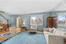This inviting living area features hardwood floors and natural light .