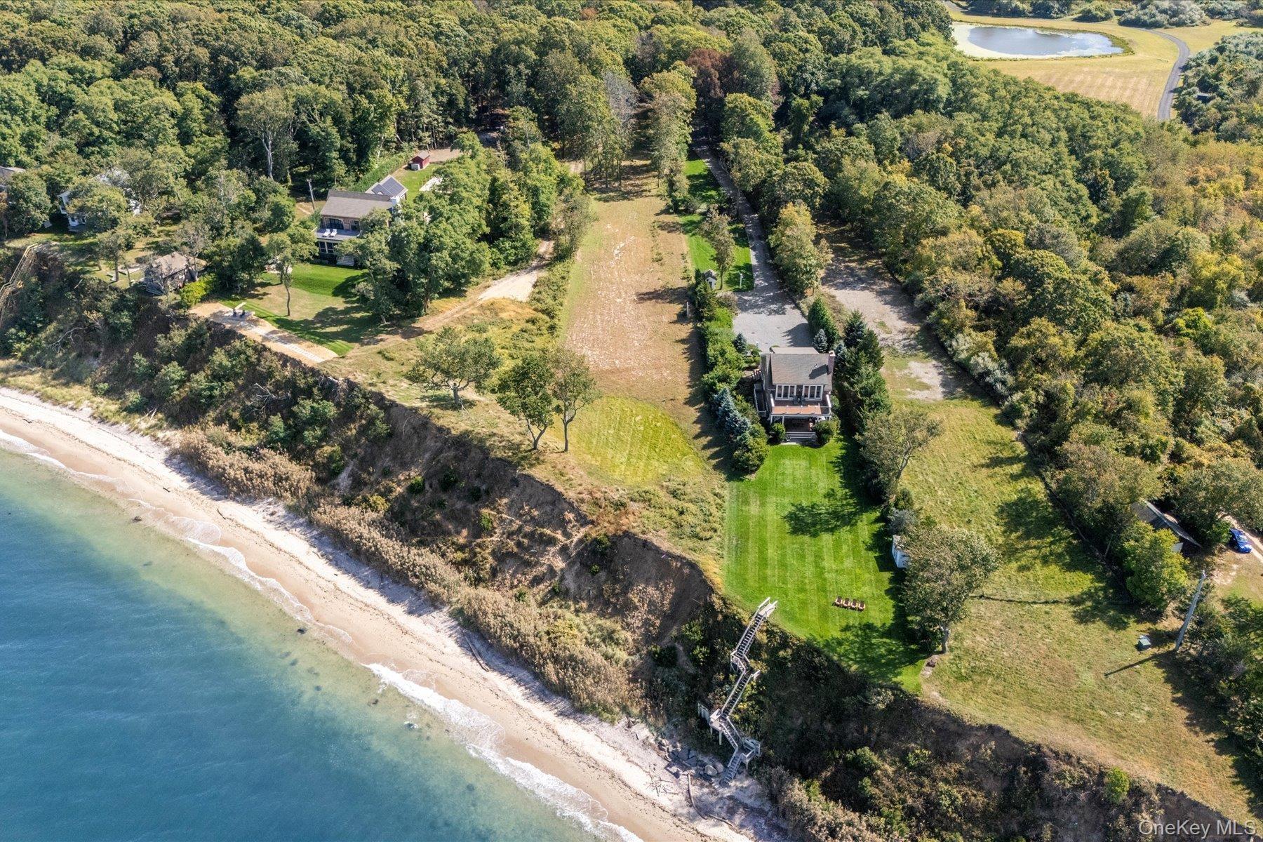 Aerial view of property and surrounding area with unending shoreline and property boundaries highlighted
