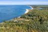 Breathtaking aerial capturing the North Fork coastline with sweeping open-water views, sandy shoreline, and scenic natural surroundings stretching int