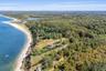 Spectacular aerial showcasing the property's location along the North Fork coastline, with sweeping shoreline views, expansive woodlands, and open-wat