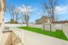View of patio featuring a fenced backyard, an outdoor structure, and a storage shed