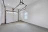 Garage with baseboards, recessed lighting, and a garage door opener