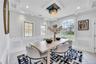 Dining space featuring marble finish floor, a decorative wall, a wainscoted wall, and recessed lighting