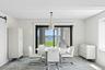 Dining area with a water view, a barn door, and wallpapered walls