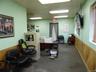 Home office with a wainscoted wall, wood walls, and a paneled ceiling