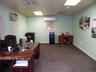 Office with dark carpet and a drop ceiling