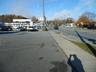 View of asphalt street with traffic signs and sidewalks