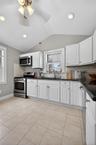 Bright sunny Kitchen with ceiling fan, recessed lighting  and plenty of space in the cabinetry.