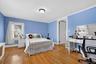 Third bedroom with hardwood floors and mouldings.