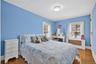 Second bedroom with hardwood floors and windows to the front.