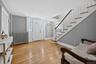 Entry to charming Colonial with deorative  front door side window panels hardwood floors and stairs to the second floor.