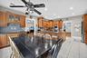 Dining area with ceiling fan, light tile patterned flooring, and recessed lighting