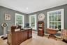 Office area featuring a baseboard radiator, light wood-type flooring, crown molding, and recessed lighting