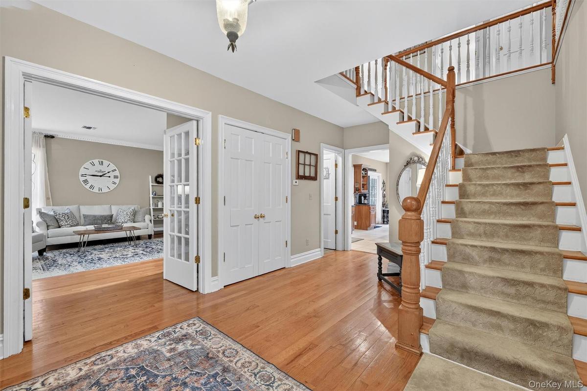 Entrance foyer with stairway and wood finished floors