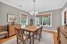 Dining space with a chandelier, ornamental molding, light wood-style flooring, and a baseboard heating unit