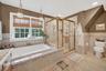 Bathroom featuring a bath, a shower stall, tile patterned flooring, tile walls, and vanity