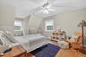 Bedroom featuring wood finished floors, a baseboard heating unit, vaulted ceiling, and ceiling fan