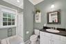 Full bathroom with crown molding, vanity, and a stall shower