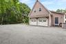 View of home's exterior featuring a garage and driveway