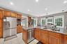 Kitchen featuring appliances with stainless steel finishes, stone counters, plenty of natural light, and recessed lighting